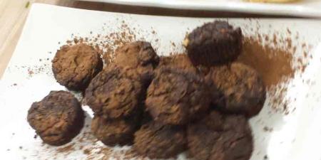 Platter of black bean brownies dusted with cocoa powder