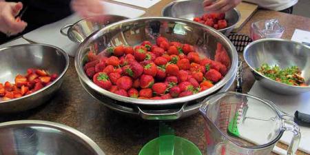 Workshop participants cutting strawberries